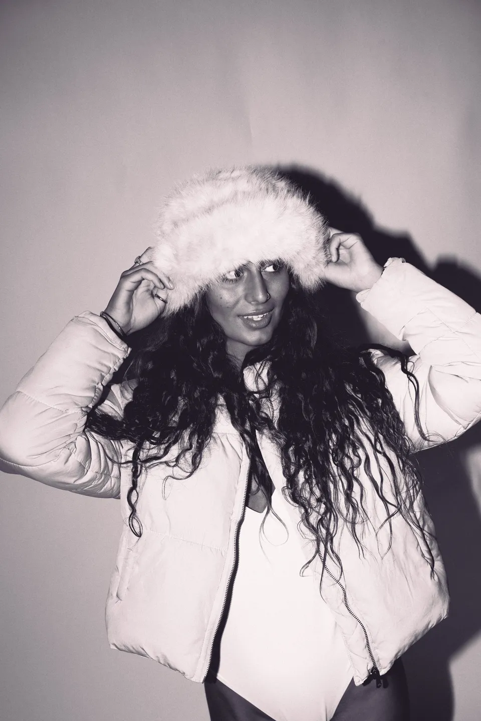 Black and white portrait of a woman in a fur hat