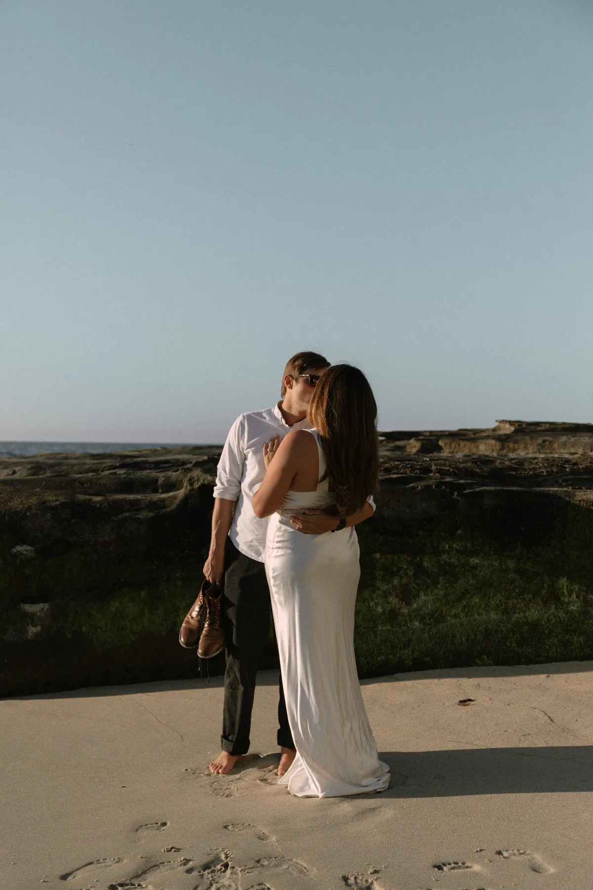 Couple at the shoreline at sunset